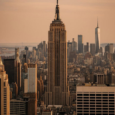New York City skyline at sunset with Empire State Building and skyscrapers.の写真素材