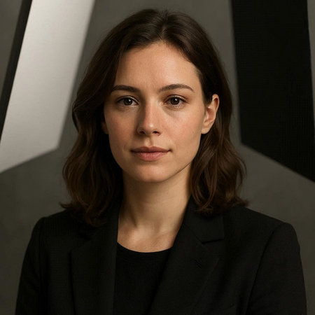 Portrait of a beautiful young woman in a black suit looking at the camera