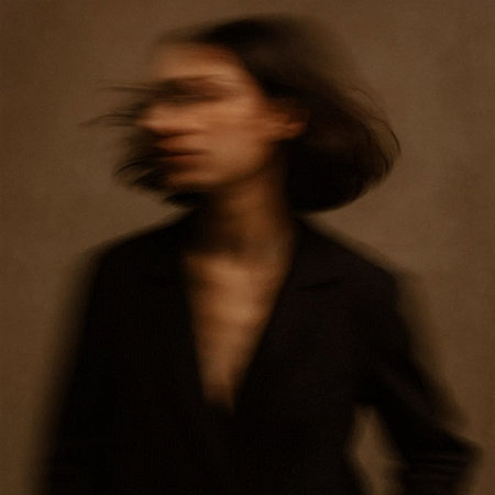 Silhouette of a woman in a black jacket with long hair