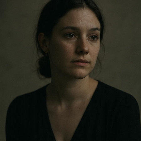 Portrait of a young woman in a black dress on a dark background