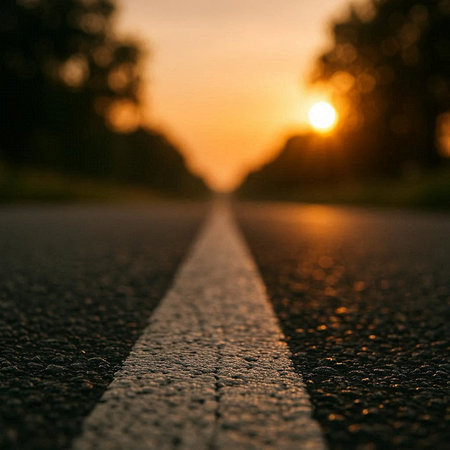 Asphalt road at sunset. Abstract blurred background. Copy space.
