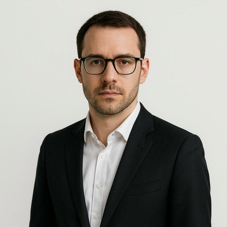 Portrait of a handsome businessman in a suit and glasses looking at camera