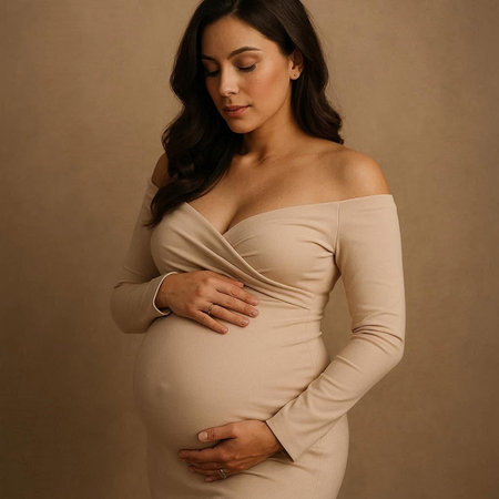 Pregnant woman in a beige dress on a brown background