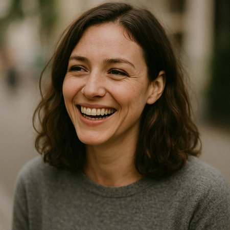 Portrait of a beautiful middle-aged woman in a gray sweater smiling.