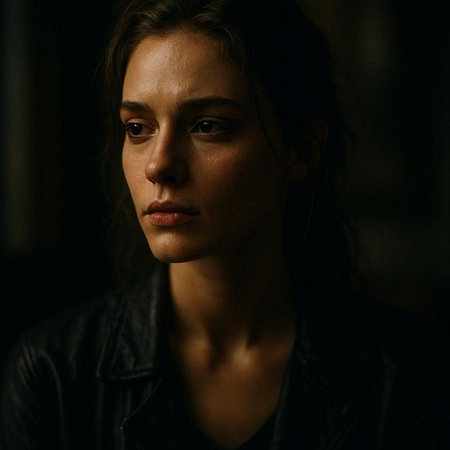 Portrait of a beautiful young woman in a black jacket on a dark background