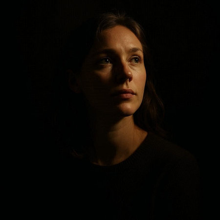 Portrait of a young woman in a dark room. Studio shot.