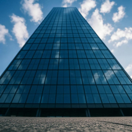 A low angle shot of a skyscraper in the middle of the city