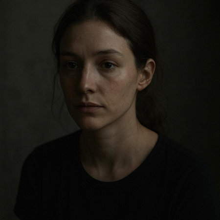 Portrait of a sad woman on a dark background. Studio shot.の写真素材