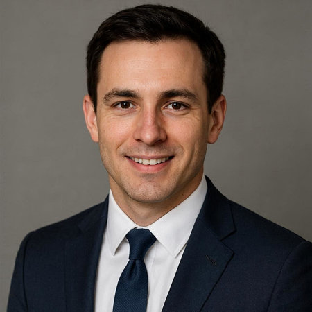 Portrait of a handsome business man smiling at the camera against grey background