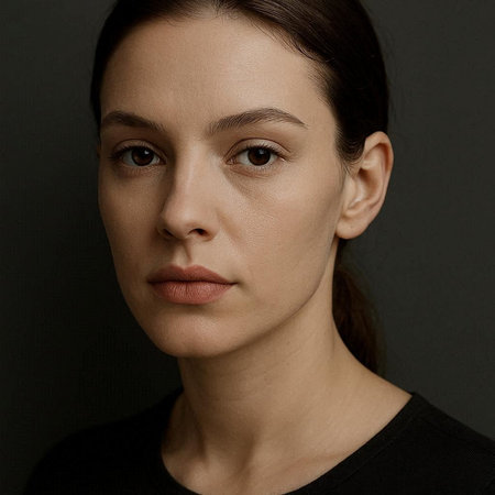 Portrait of beautiful young woman looking at camera. Studio shot.