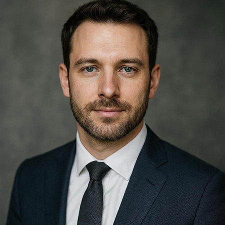 Portrait of a handsome young man with a beard in a suit