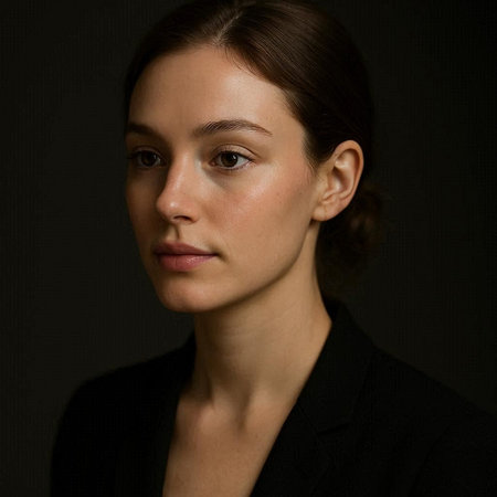 Portrait of a young woman in a black jacket on a black background