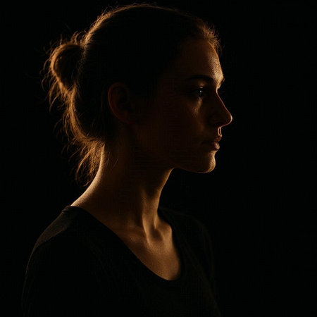 Portrait of a young woman on a dark background. Studio shot.