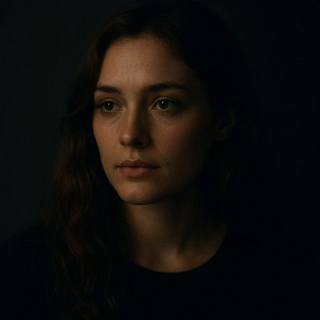 Portrait of a young woman on a dark background. Studio shot.