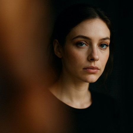 Portrait of beautiful young woman in black dress looking at camera.