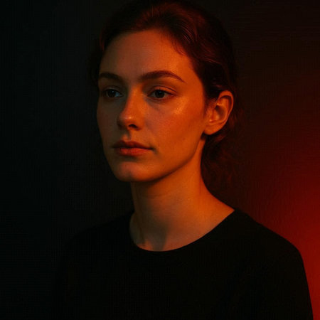 Portrait of a beautiful young woman with red light on her face