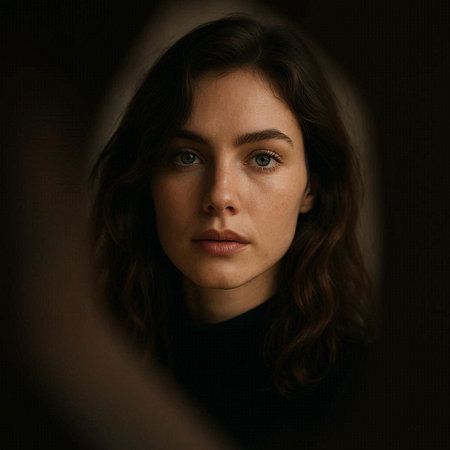 Portrait of a beautiful woman with long brown hair in a dark room