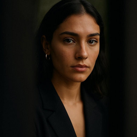 Portrait of a beautiful woman in a black suit on a dark backgroundの写真素材