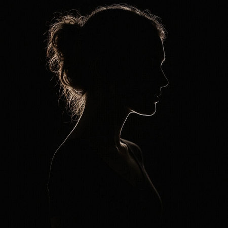 Silhouette of a beautiful young woman on a black background.