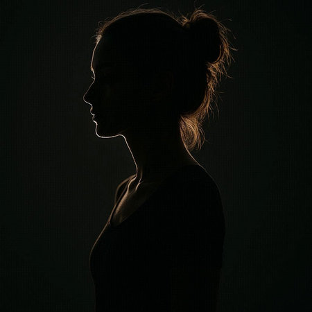 Silhouette of a beautiful young woman on a dark background.