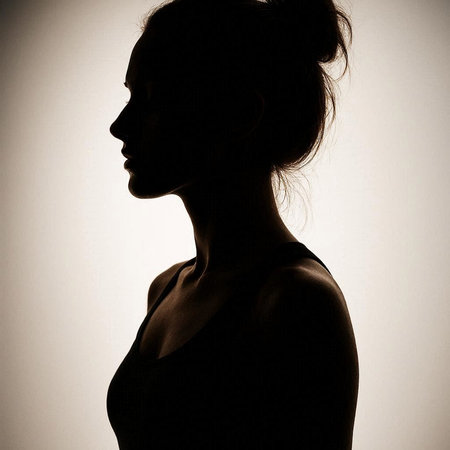 Silhouette of a beautiful brunette woman in a black dress
