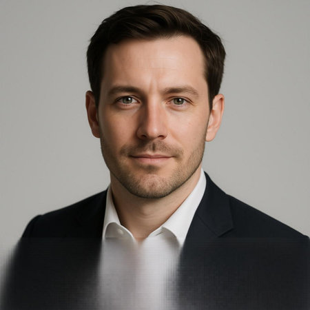 Portrait of a handsome young businessman looking at the camera, over grey background