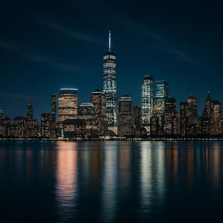 New York City Manhattan skyline at night with reflection in the water.