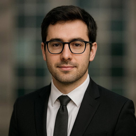 Portrait of a handsome young businessman in a suit and glasses.