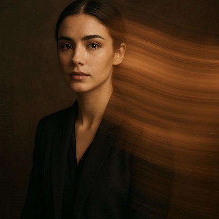 portrait of a beautiful brunette woman in a black suit on a dark backgroundの写真素材