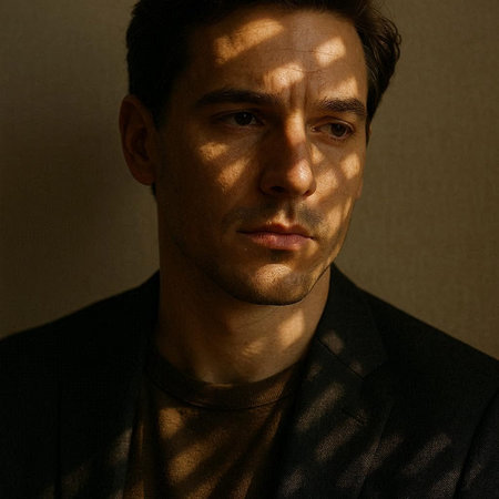 Portrait of a handsome young man with shadow on his face.