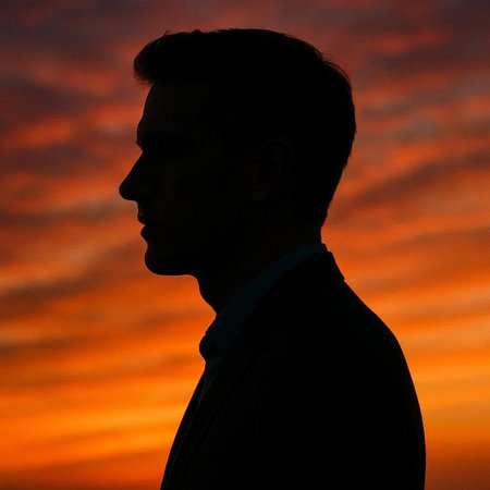 Silhouette of a man on a background of a sunset.