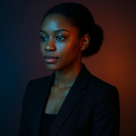Portrait of a beautiful African American woman in a business suit against a dark background