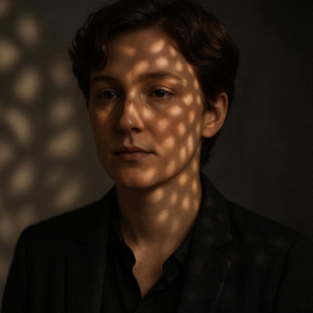 Portrait of a handsome young man with shadows on his face.