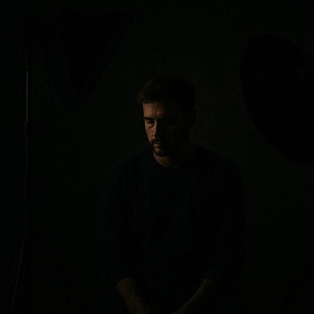 Portrait of a young man in the studio on a dark background