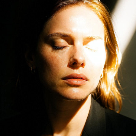 Close-up portrait of a beautiful young woman with closed eyes.