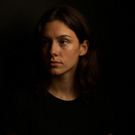 Portrait of a beautiful young brunette woman on a black background