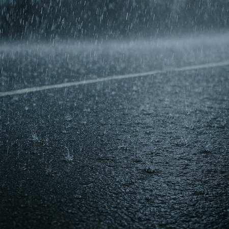 Rain drops on asphalt road. Shallow depth of field. Toned.