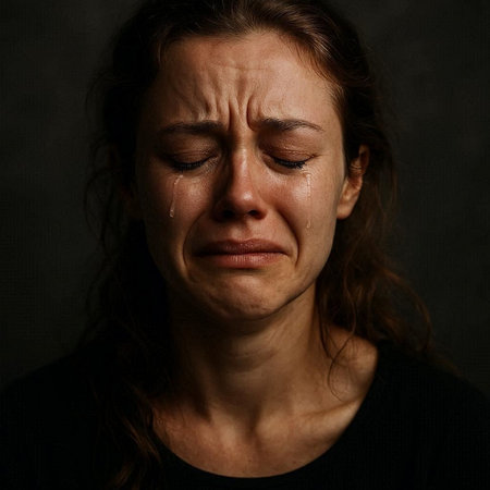 Portrait of a crying woman with tears in her eyes on a dark background