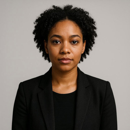 Portrait of a young African American woman in a black suit on a gray background