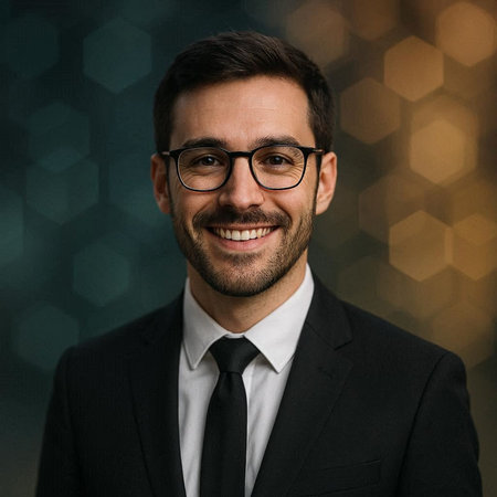 Portrait of a handsome smiling businessman wearing glasses and a suit.