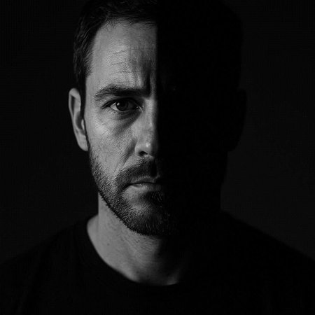 Portrait of a handsome man with a beard on a black background