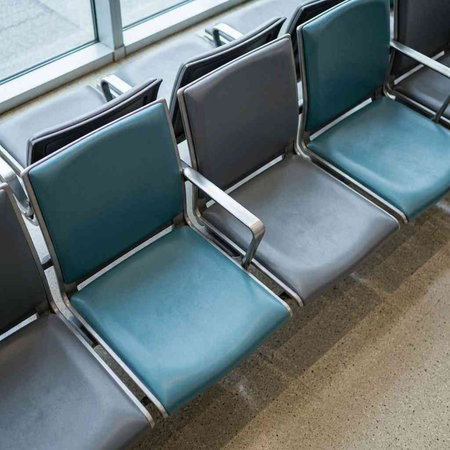 Empty chairs at the airport waiting area for a flight. Travel concept