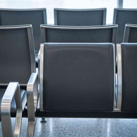 Empty chairs in a waiting room of a modern airport. Selective focus.