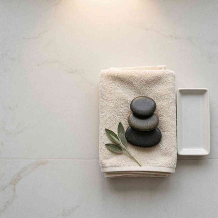 Spa stones and towel on white marble background. Relaxation and meditation concept.