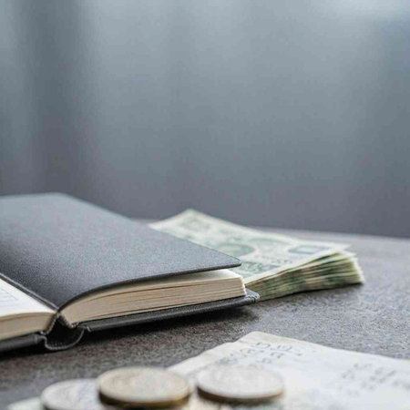 Open book with money on the table. Selective focus. Place for text.