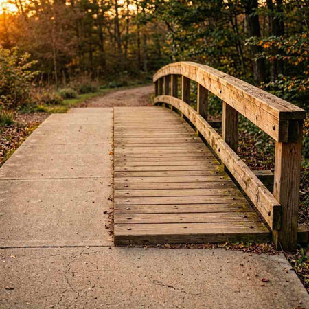 Wooden bridge in the park at sunset. Beautiful autumn landscape.