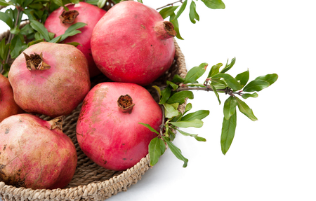 Freshly pomegranates in a basketの写真素材