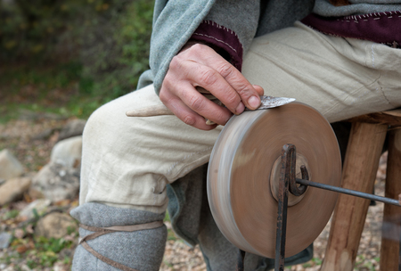 The knife grinder works in a small medieval villageの写真素材