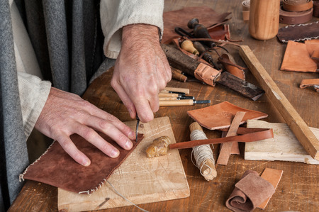 the expert craftsman works leather in his workroomの写真素材