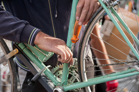 Mechanic prepares the bicycle before the raceの写真素材